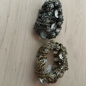 Two stretch bracelets, one with gold and clear stones the other pewter